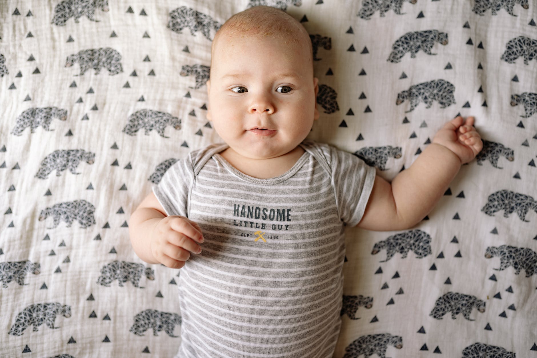 baby boy lying on back